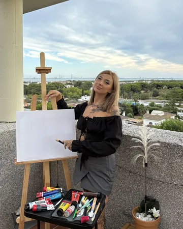 Diana beside her easel on a terrace, a blank canvas ready